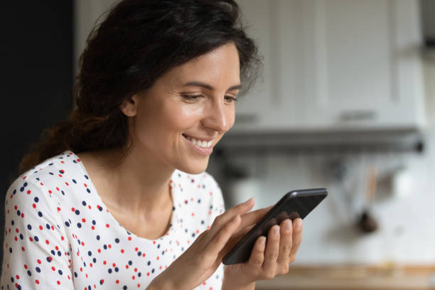 istock Happy Hispanic woman using apps and services on mobile phone 1402932828