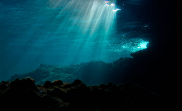 Lights underwater Underwater photo of beautiful rays of light over the reef. From a scuba dive land feature stock pictures, royalty-free photos & images