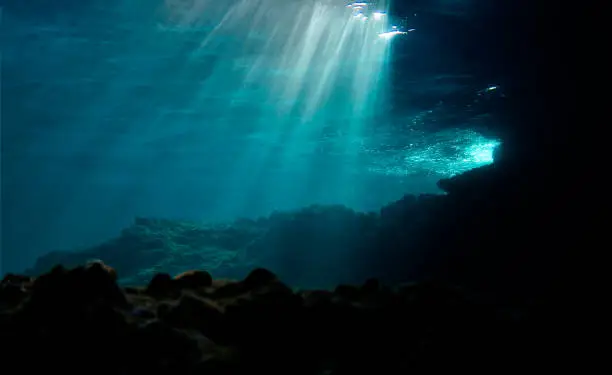Underwater photo of beautiful rays of light over the reef. From a scuba dive