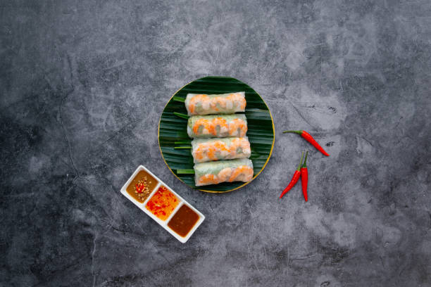 Fresh shrimp, prawn Spring Roll served in bowl isolated on dark grey background top view of japanese food