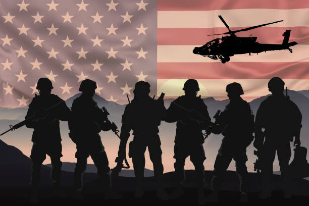 Silhouettes of soldiers with American flag background stock photo