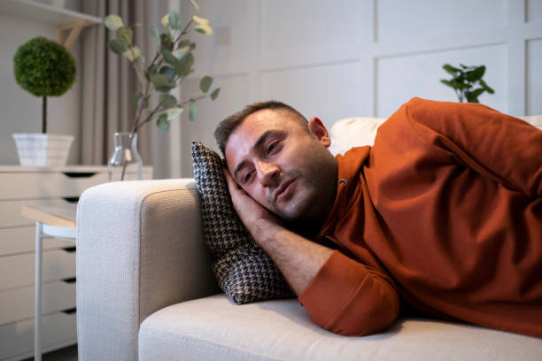 istock Man alone at home looking sad and distraught 1402941448