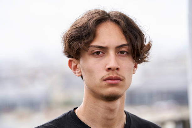 istock Sulky teenage boy looking at camera 1402942222