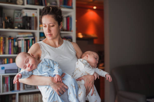 Mother Embraces Her Twin Children