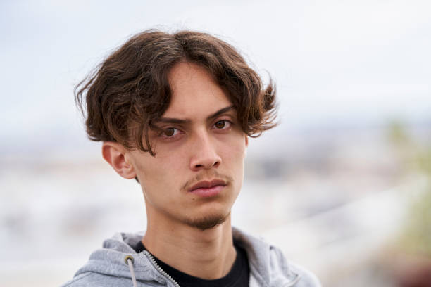 istock Front view of morose Generation Z boy looking at camera 1402942238
