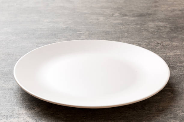 istock Perspective view of empty light plate on cement background. Empty space for your design 1402942327
