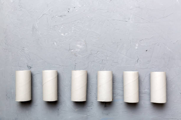 istock Flat lay composition with empty toilet paper rolls and space for text on color background. Recyclable paper tube with metal plug end made of kraft paper or cardboard 1402942345