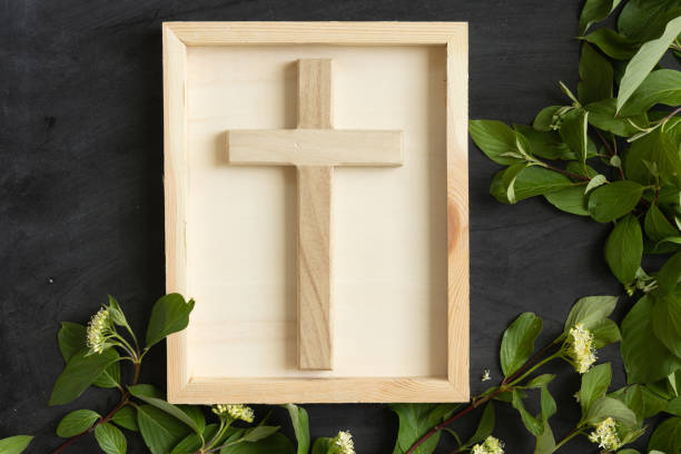 istock Wood cross on chalkboard background with green vine border 1402943447