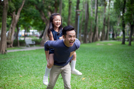 Asian Father Giving Daughter Ride On Shoulders In Park Taipei