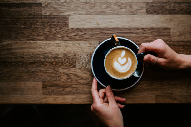 istock Woman hands holding latte art 1402943697