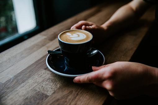 Woman hands holding latte art