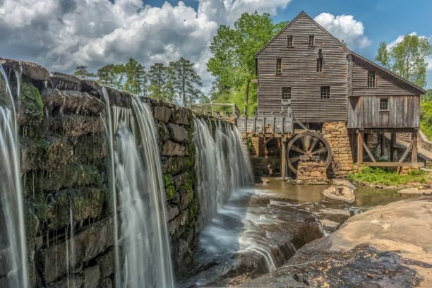 istock Old building with water wheel and dam 1402944760