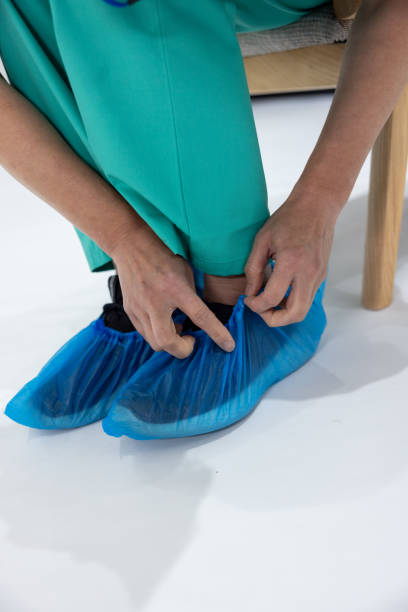 istock Surgeon putting on shoe cover before operation 1402946054