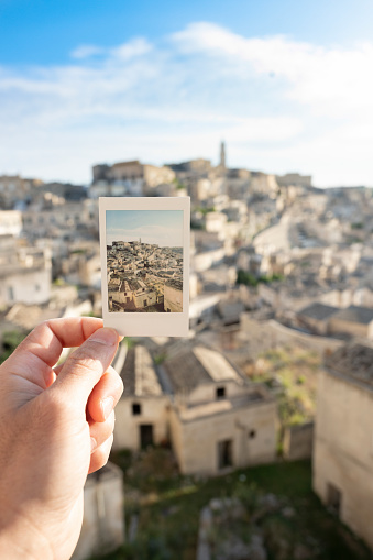 (Selective focus) Stunning view of the Matera’s skyline seen through an instant film taken during a sunny day. Matera is a city on a rocky outcrop in the region of Basilicata, in southern Italy.
