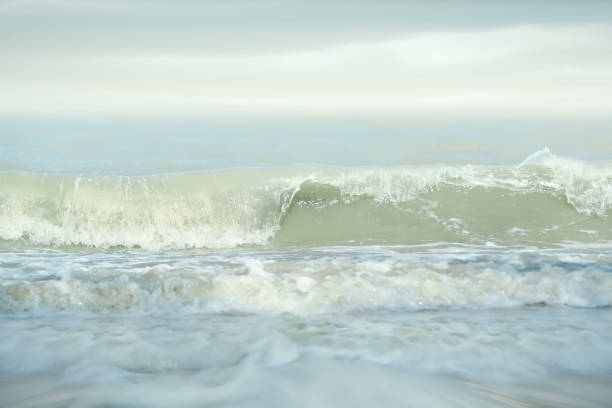 istock Splashing sea waves on sunny day. 1402949227