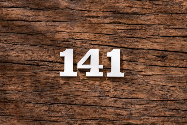 istock Number 141 in wood, isolated on rustic background 1402952768