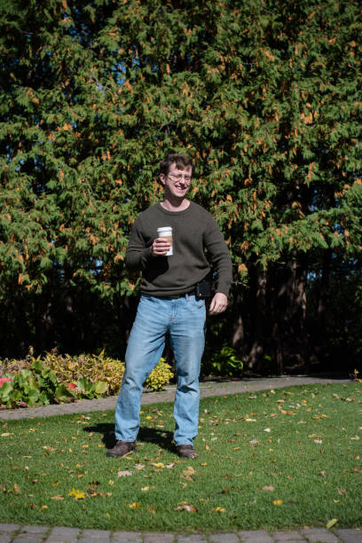 istock Confident Man with a coffee, squints in the sunlight. 1402962606