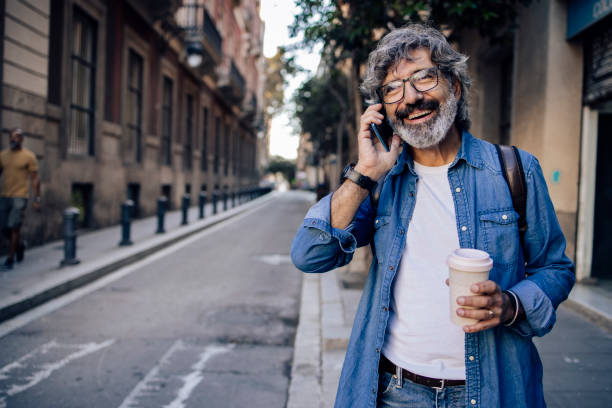 istock Mature tourist telephoning while sightseeing Barcelona 1402962871