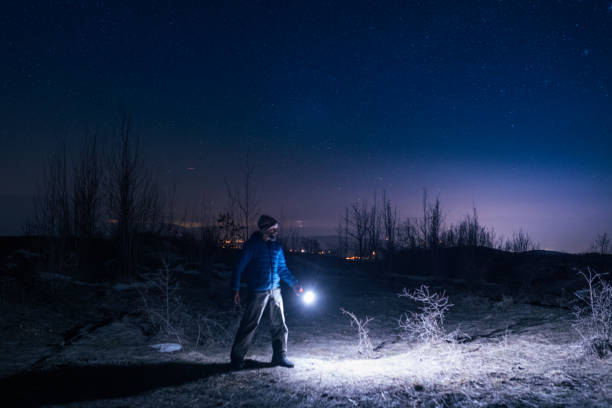 istock Man with light at night in nature. 1402962958