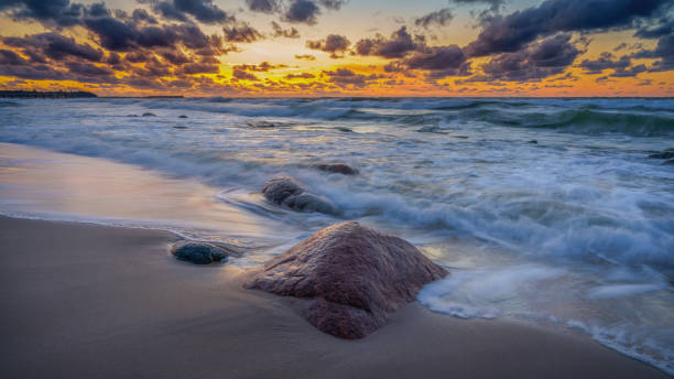 istock colorful sunset on the rocky seashore 1402964009