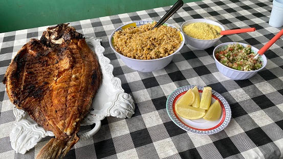 Amazonian Dish with Pirarucu Fish and Sides at a table