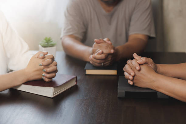 istock Asian Christian groups sitting within the Church Catholic prayed for blessings from God. A pale sun shone in a place of worship.Religious concepts. 1402974036
