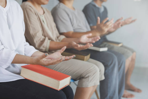 istock Asian Christian groups sitting within the Church Catholic prayed for blessings from God. A pale sun shone in a place of worship.Religious concepts. 1402974119