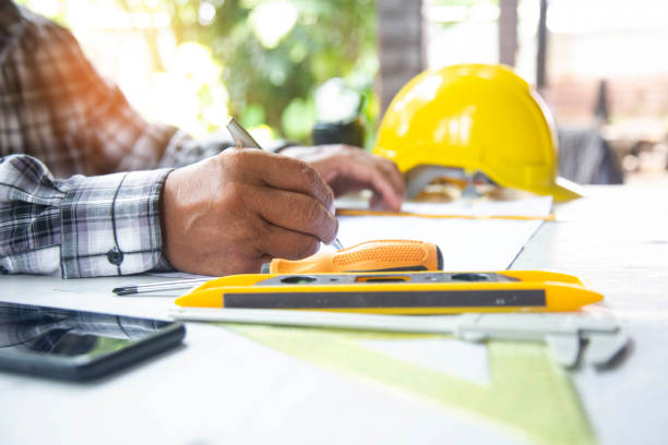 istock architect asian old man working with blueprints,engineer inspection in workplace construction site 1402974653