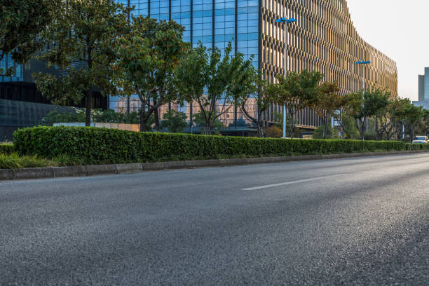 istock empty asphalt road near glass office building 1402975104