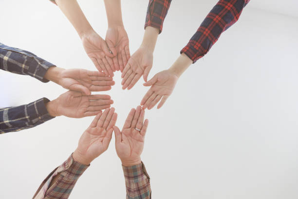 istock Young businessmen put their hands together, Working as a team together supports a common idea. 1402976047