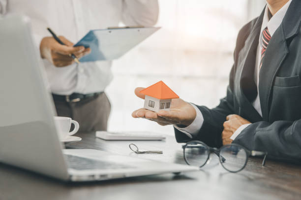 istock Real estate agent. Home purchase contract and asking customers to sign documents. Home insurance concept. 1402976063