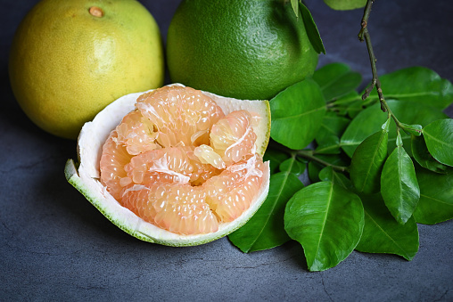 Fresh Grapefruit with leaves on Wooden background, Grapefruit or Yellow Pomelo on Wooden background.
