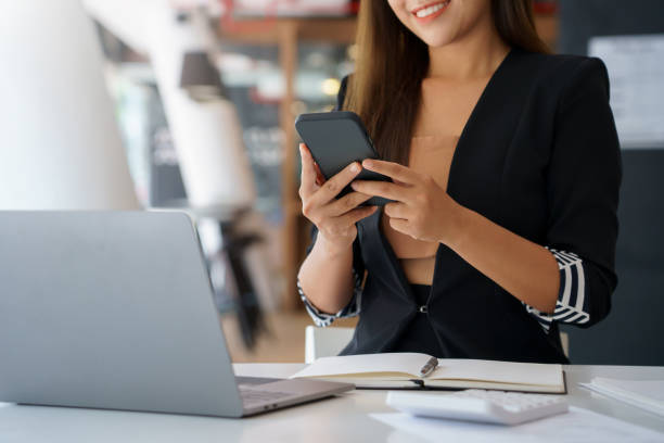 istock Woman using smartphone to send text , work or play social media. 1402976947