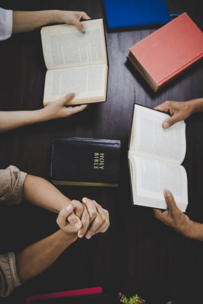 istock Group of people praying worship believe 1402980841