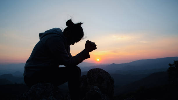 istock woman worship on sunset 1402981502