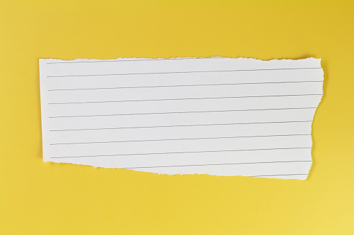 Ripped paper, torn notebook paper on yellow background space for copy