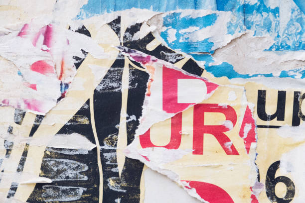 istock Torn street poster background, abstract weathered paper collage with random text 1402984873
