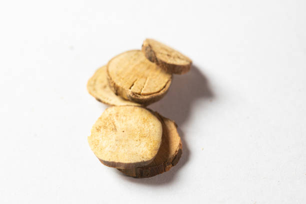 Dry organic Sugandh Mantri (Homalomena aromatica), along with its essential oil. Isolated on a white background.
