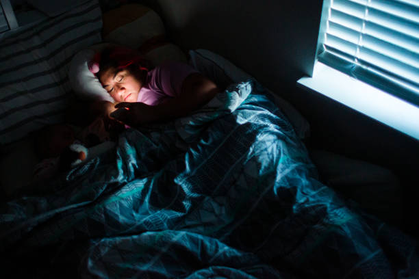 istock Woman Using Phone in Bed at Nighttime 1402989584