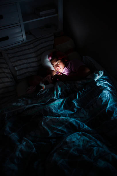 istock Woman Using Phone in Bed at Nighttime 1402989590