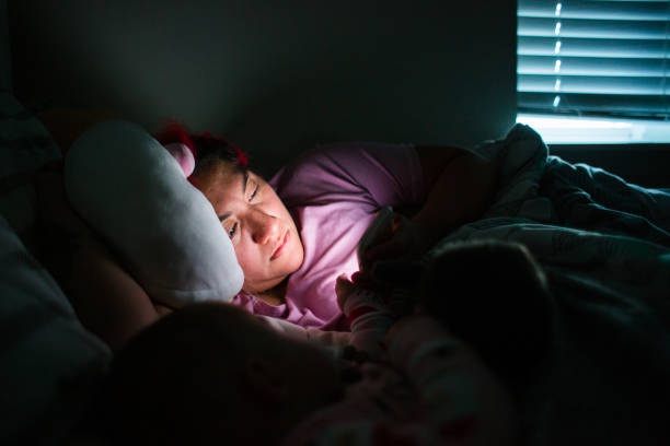 istock Woman Using Phone in Bed at Nighttime 1402989591