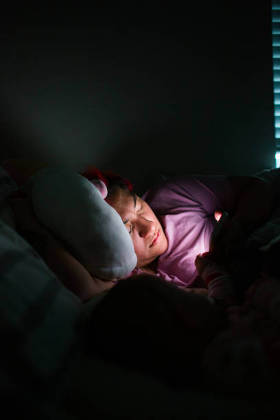 istock Woman Using Phone in Bed at Nighttime 1402989592