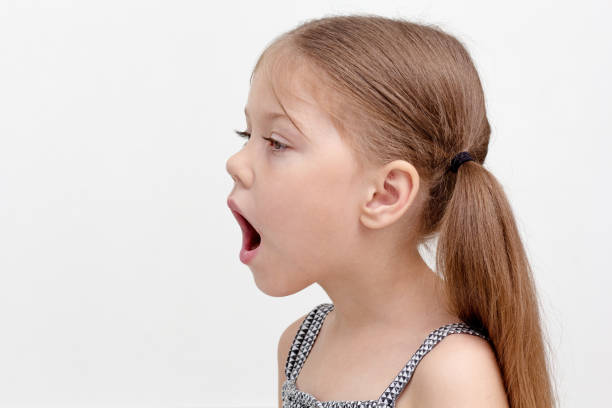 Cute little girl making a shocked face over white background