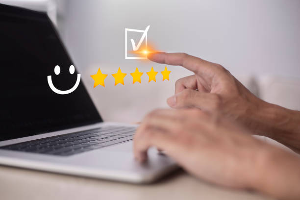 istock Satisfaction and customer service survey concept, business people using laptops. to answer the question And the satisfaction rating, the satisfaction rating with the smiley face icon 5 stars. 1402990625