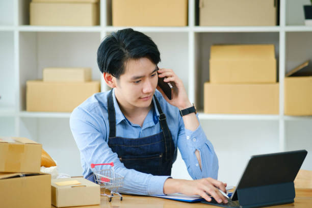 istock Young Asian businessman working talking. 1402991675