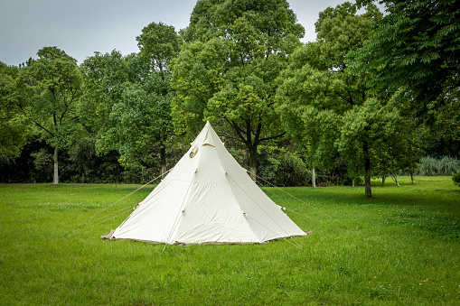 Glamping camping teepee tent and chairs at the campsite.