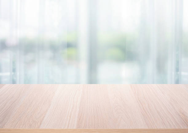 istock Select tive focus.Empty wood table top on blur abstract window glass background. 1402996495