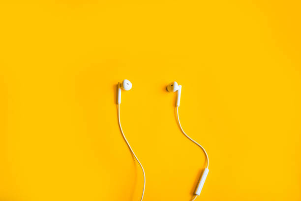 istock Top view of earphone on yellow background 1402998734