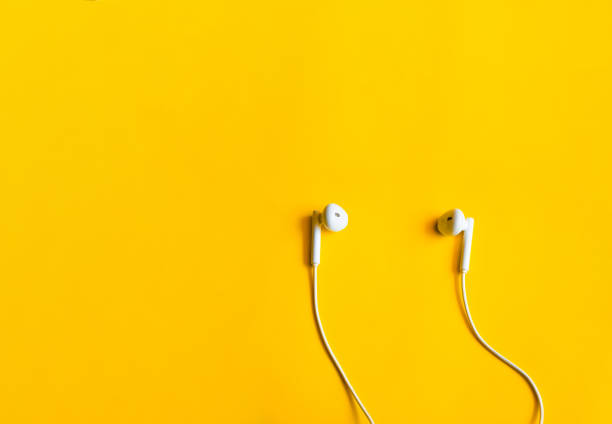 istock Top view of earphone on yellow background 1402998738