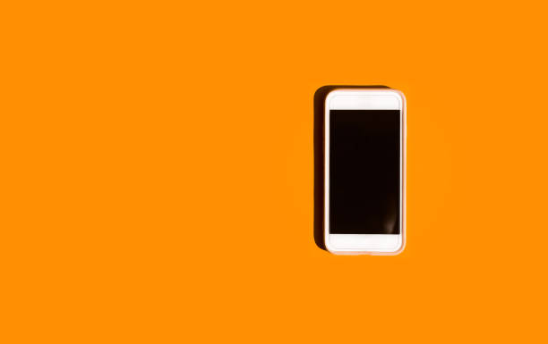 istock Mobile phone or smartphone on colored orange background 1402998984